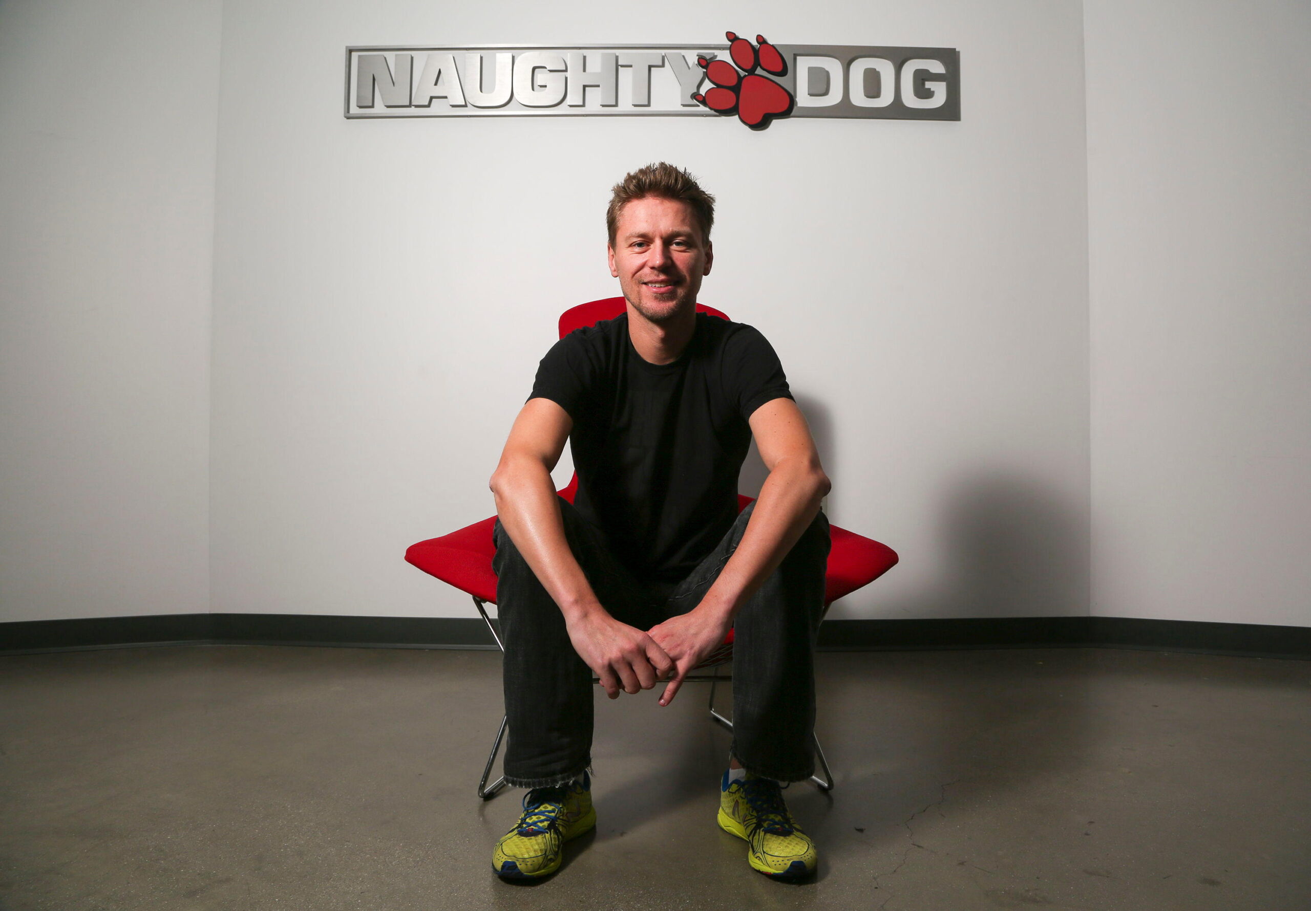 Christophe Balestra, co-president of Naughty Dog poses in front of the game studio logo