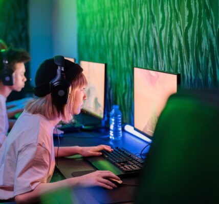 several people sitting in a gaming cafe playing Atomfall